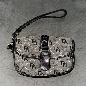 Authentic gentle used Dooney Bourke wristlet with gold hardware. Black and cream